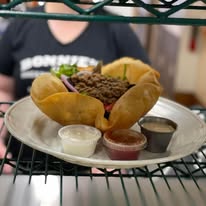 Bonnie Burger on a homemade roll with dipping sauces