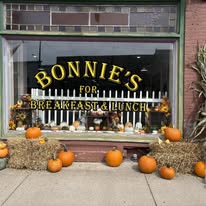 Bonnie's storefront with pumpkins and hay bales, warm fall vibes on Genesee Street