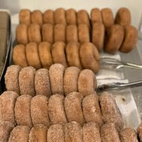 Rows of fresh sugar-coated donuts, golden brown and made from scratch at Bonnie's