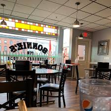 Bonnie's dining room with tables, chairs, and stained glass windows
