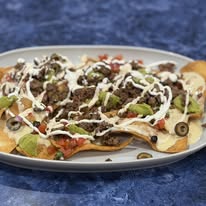 Loaded nachos with ground beef, olives, and sour cream at Bonnie's